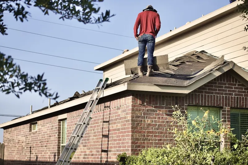Professional roofer working on a residential roof in Germantown Road Acres